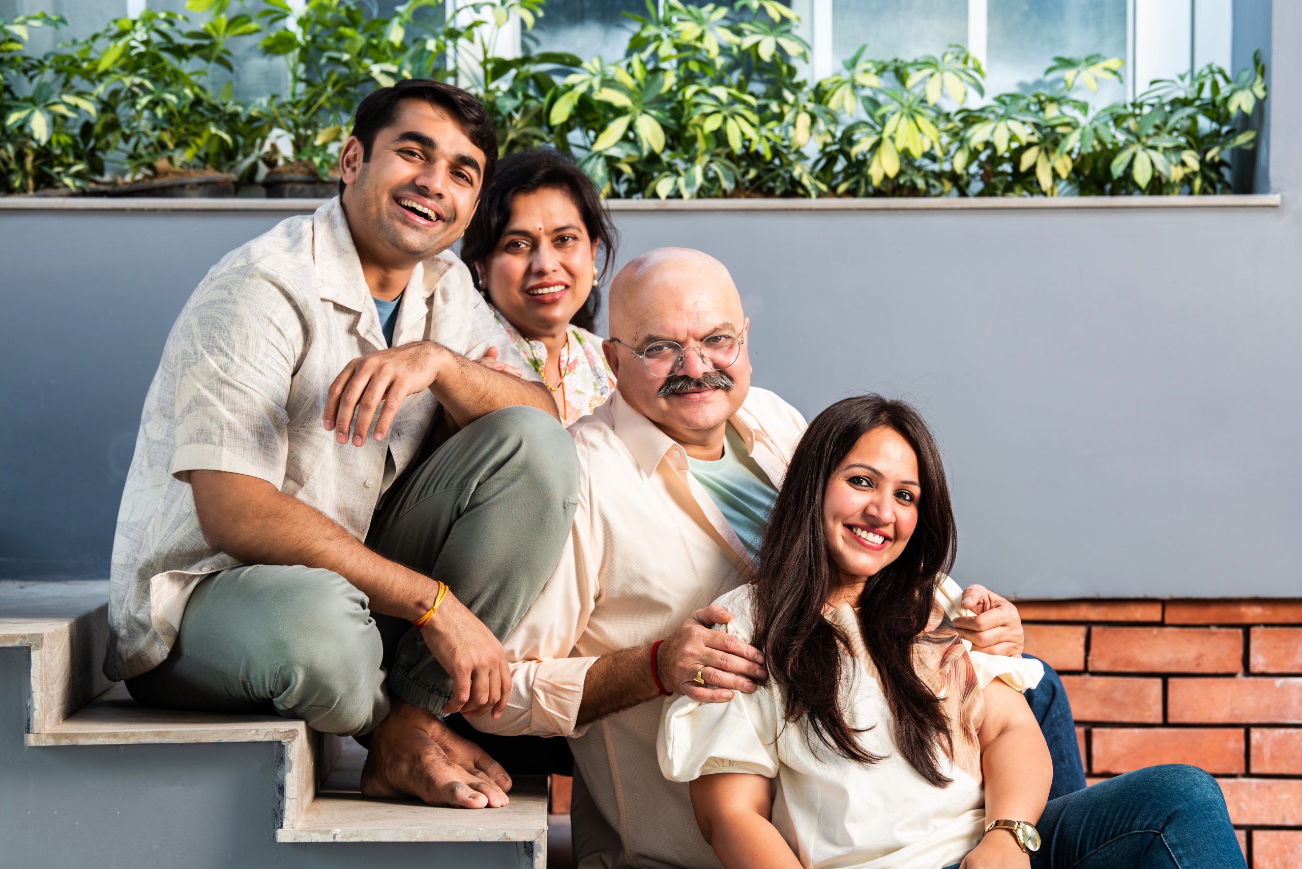 Happy Indian Family sitting together on stairs outside home